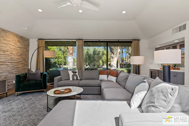 a living room with furniture and a large window