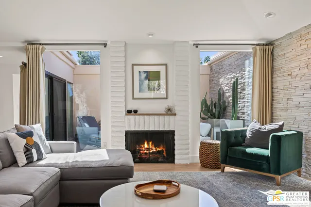 a living room with furniture and a fireplace