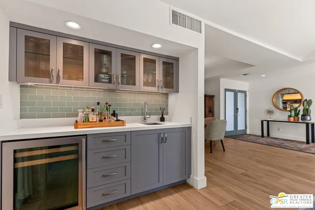 a kitchen with a wooden floor and cabinets