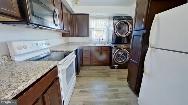a view of cabinets with wooden floor washer and dryer