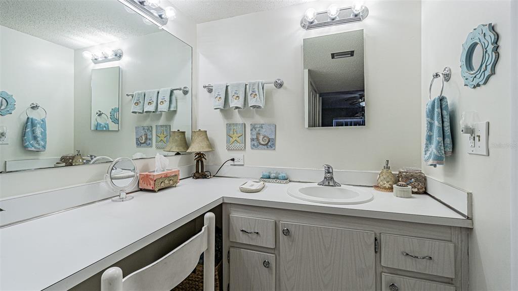 7 Elgin Place, Unit 301 Dunedin, FL 34698 - Photo 14 of 35 a bathroom with a sink and a mirror