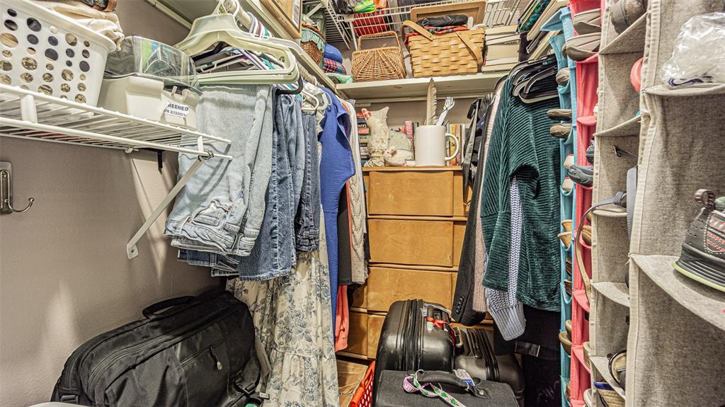 7 Elgin Place, Unit 301 Dunedin, FL 34698 - Photo 15 of 35 a view of walk in closet with clothes and shoes