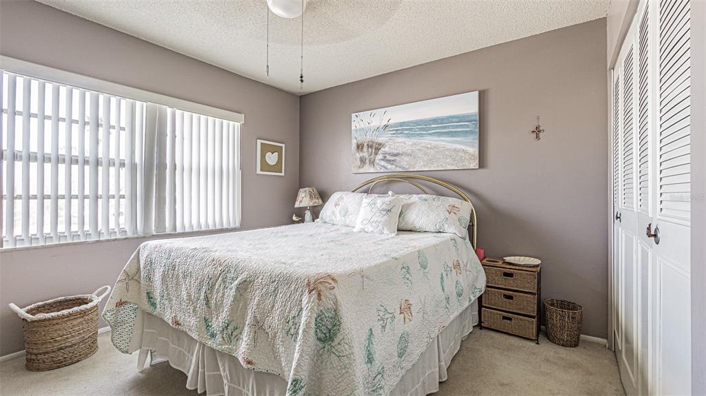 7 Elgin Place, Unit 301 Dunedin, FL 34698 - Photo 18 of 35 a bedroom with a bed and a window