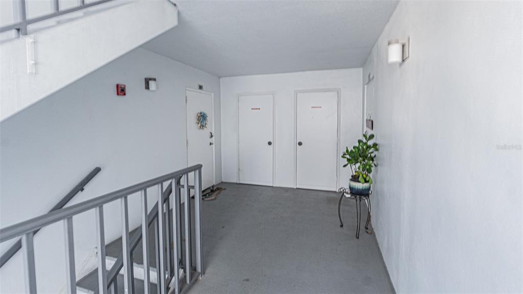 7 Elgin Place, Unit 301 Dunedin, FL 34698 - Photo 20 of 35 a view of a hallway with wooden floor