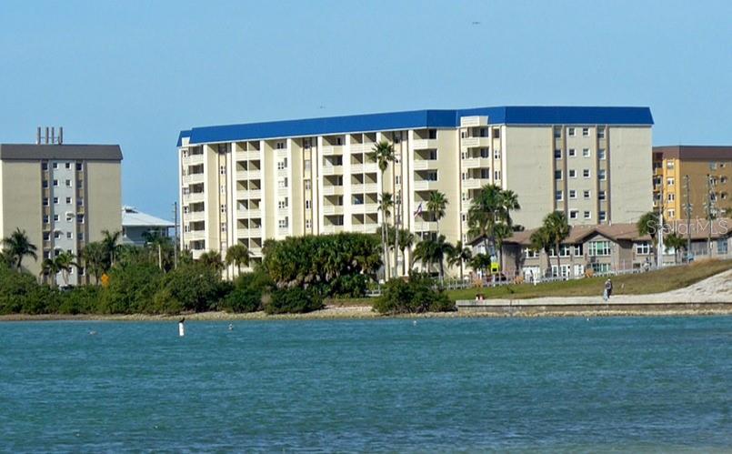 7 Elgin Place, Unit 301 Dunedin, FL 34698 - Photo 2 of 35 a front view of a house with a yard