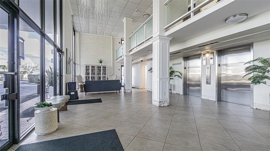 7 Elgin Place, Unit 301 Dunedin, FL 34698 - Photo 21 of 35 a lobby with furniture and a potted plant