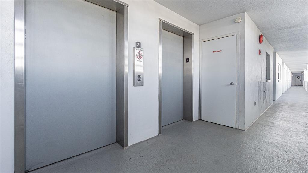 7 Elgin Place, Unit 301 Dunedin, FL 34698 - Photo 22 of 35 a view of a hallway with closet area