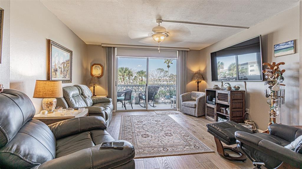 7 Elgin Place, Unit 301 Dunedin, FL 34698 - Photo 4 of 35 a living room with furniture and a large window