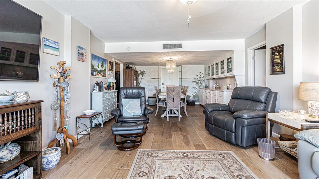7 Elgin Place, Unit 301 Dunedin, FL 34698 - Photo 8 of 35 a living room with furniture and wooden floor