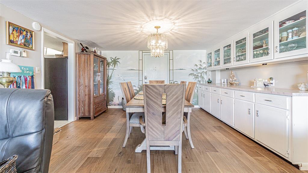 7 Elgin Place, Unit 301 Dunedin, FL 34698 - Photo 9 of 35 a view of a kitchen with furniture and a refrigerator