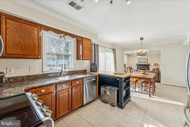 a kitchen with stainless steel appliances granite countertop a refrigerator stove and sink