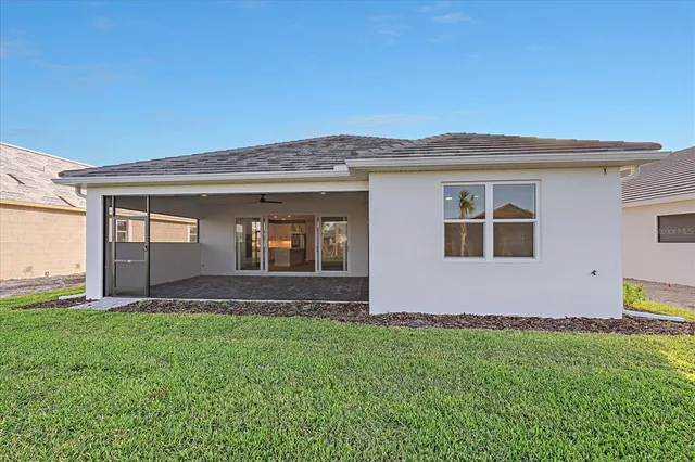 a view of a living room and floor to ceiling window with wooden floor