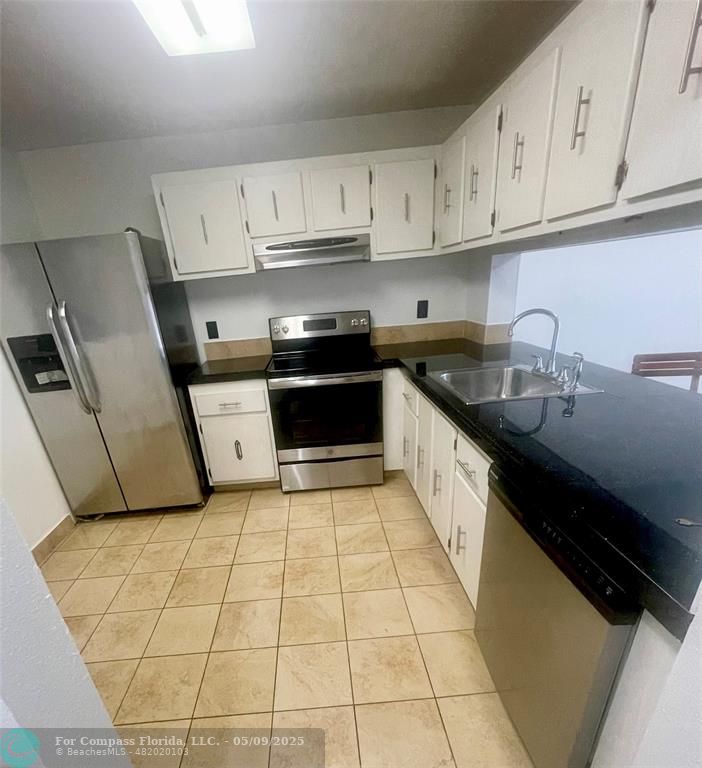 7175 Orange Drive, Unit 216H Davie, FL 33314 - Photo 1 of 14 a kitchen with stainless steel appliances a sink a stove a refrigerator and cabinets