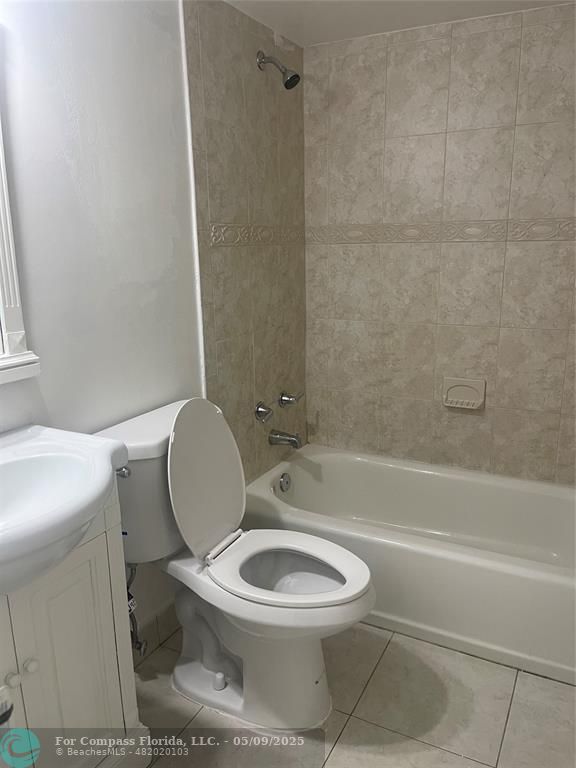 7175 Orange Drive, Unit 216H Davie, FL 33314 - Photo 14 of 14 a white toilet sitting next to a bath tub