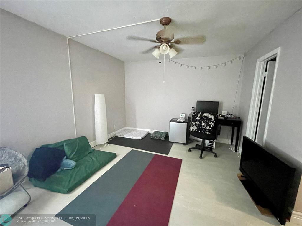 7175 Orange Drive, Unit 216H Davie, FL 33314 - Photo 2 of 14 a living room with furniture and a chandelier