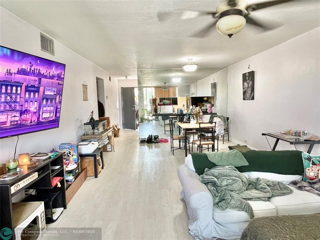 7175 Orange Drive, Unit 216H Davie, FL 33314 - Photo 4 of 14 a living room with furniture and a flat screen tv