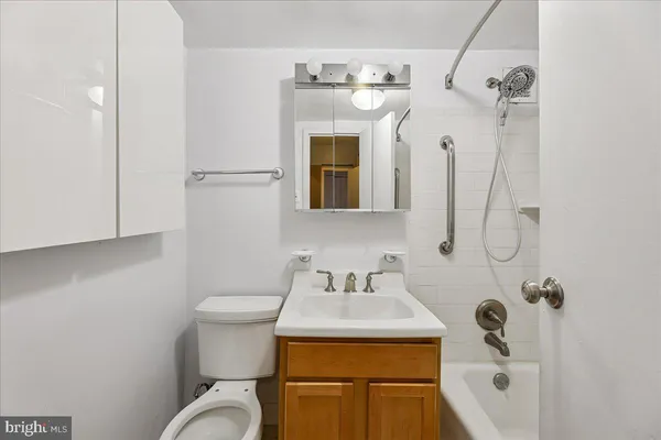 a bathroom with a sink mirror and toilet