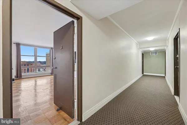 a view of a hallway with wooden floor