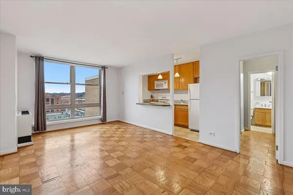 a view of an empty room with a kitchen