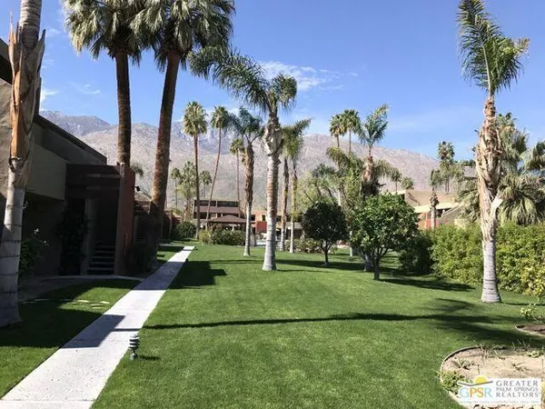 a view of a park with swings and slides