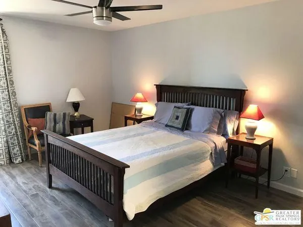 a bedroom with a bed and a lamp on table