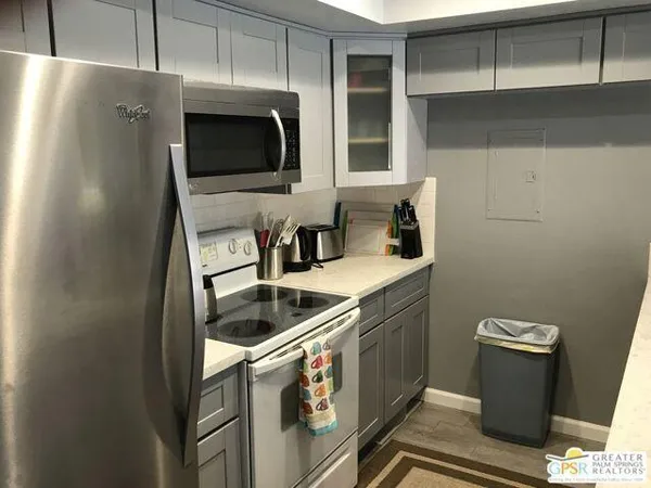 a kitchen with stainless steel appliances granite countertop a sink and a microwave