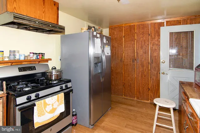 a bedroom with a bed and a refrigerator