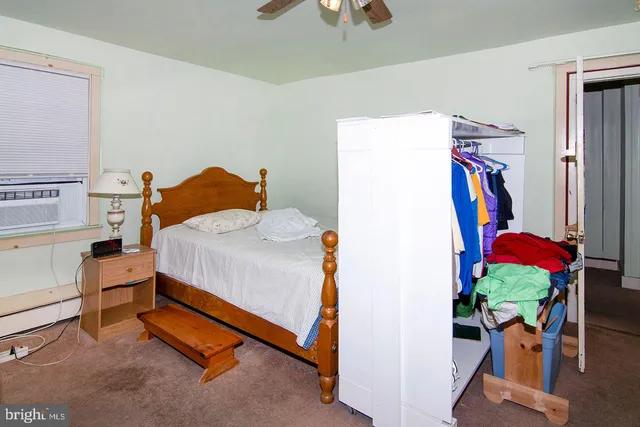 a view of a house with a big yard and large trees