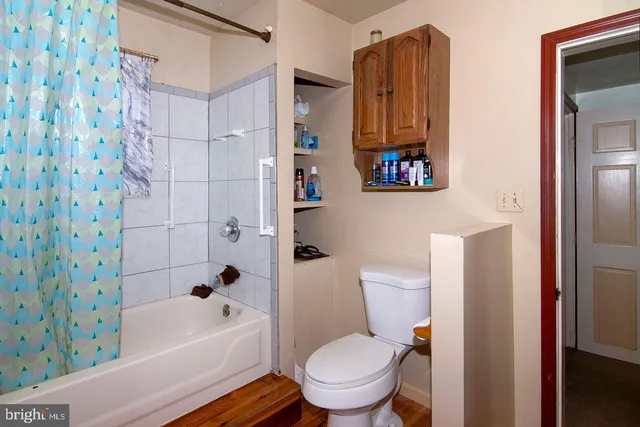 a view of a house with a big yard and large trees