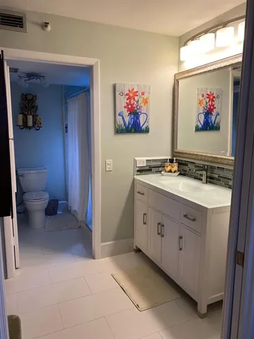 a view of a door and a microwave in a cabinet