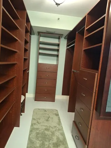 a living room with a furniture and a dresser