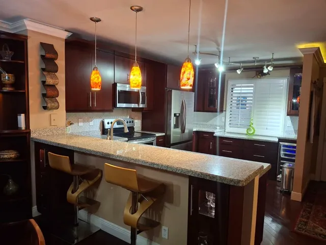 a kitchen with a stove and a refrigerator