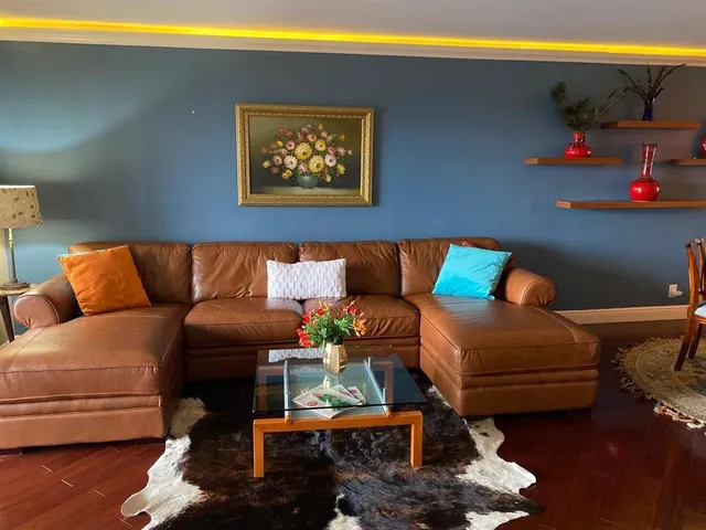 a living room with furniture and a floor to ceiling window