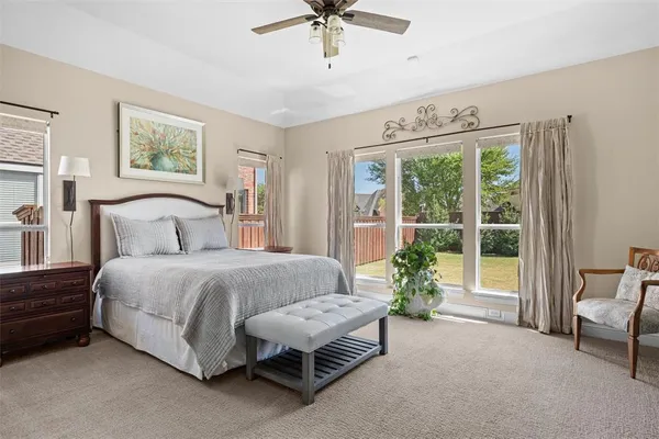 a living room with furniture kitchen view and large windows