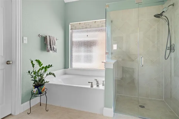 a en suite bathroom with a granite countertop sink and a mirror