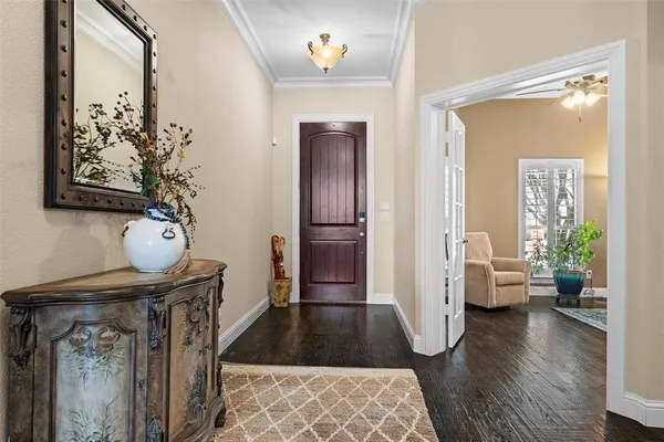 a hallway view with furniture and wooden floor