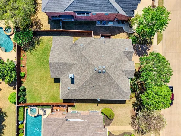 an aerial view of a house with table and chairs