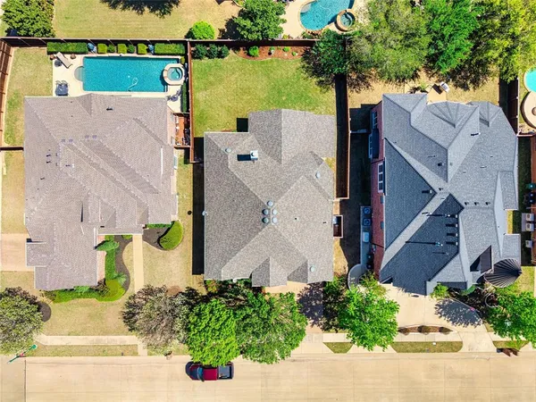 an aerial view of a house with swimming pool and porch