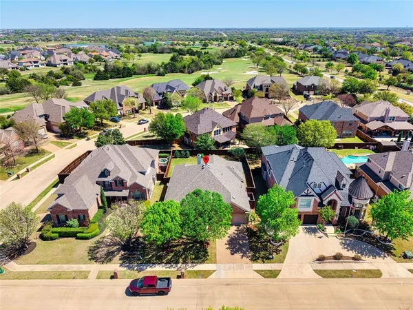 an aerial view of a house with a garden and lake view