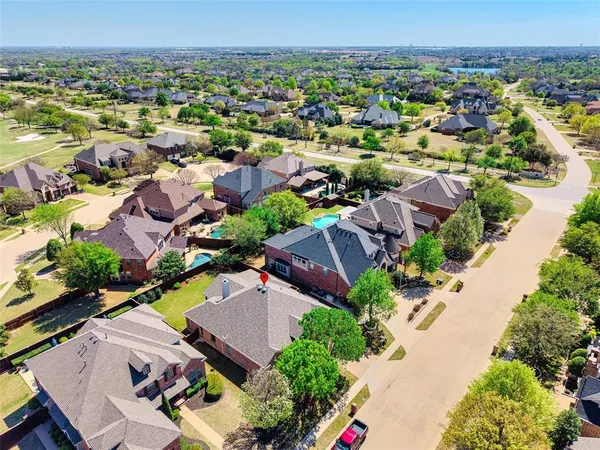 an aerial view of residential houses with outdoor space