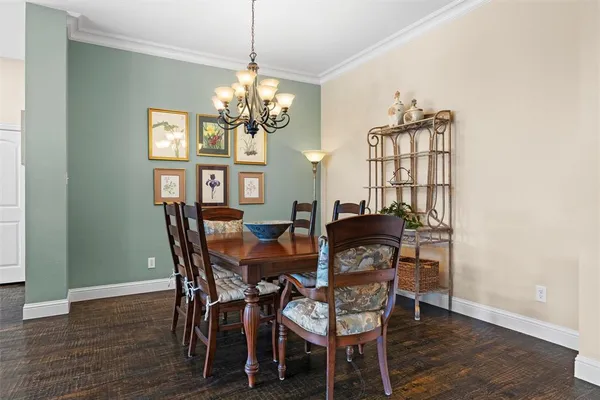 a view of a dining room with furniture and chandelier