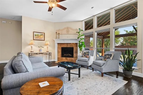 a kitchen with stainless steel appliances granite countertop a stove top oven a sink dishwasher a dining table and chairs with wooden floor