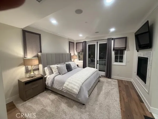 a spacious bedroom with a large bed and a flat screen tv
