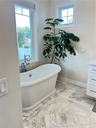 a bathroom with a double vanity sink mirror and shower