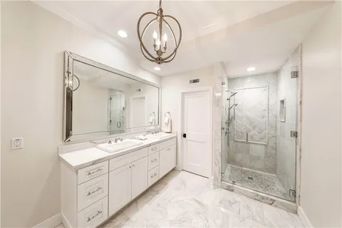 a bedroom with a bed and a lamp on dresser