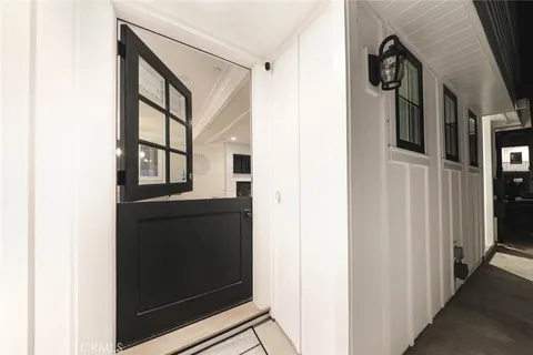 a kitchen with granite countertop a sink dining table and chairs
