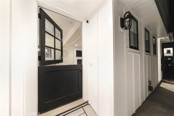 a view of an entryway and hall with wooden floor