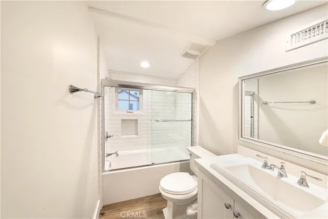 a view of a pathway of house with flower pots