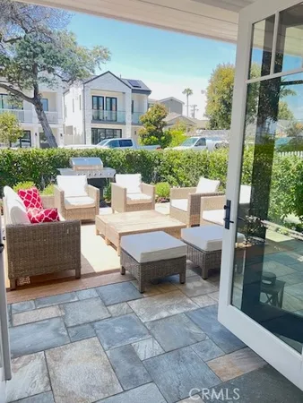 a view of a patio with couches table and chairs and potted plants