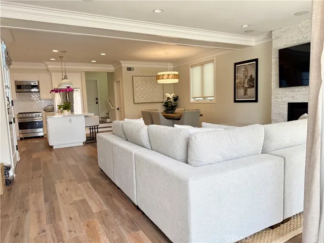 a living room with furniture a large window and a flat screen tv